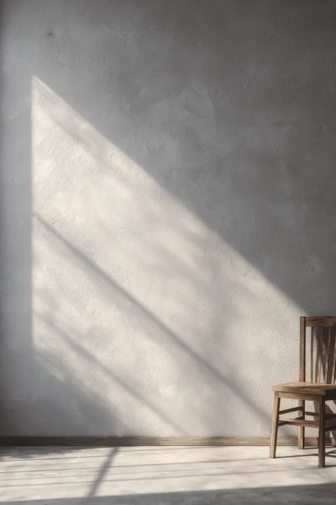 A serene interior scene showing a blank wall in natural light, inviting observation before decoration.